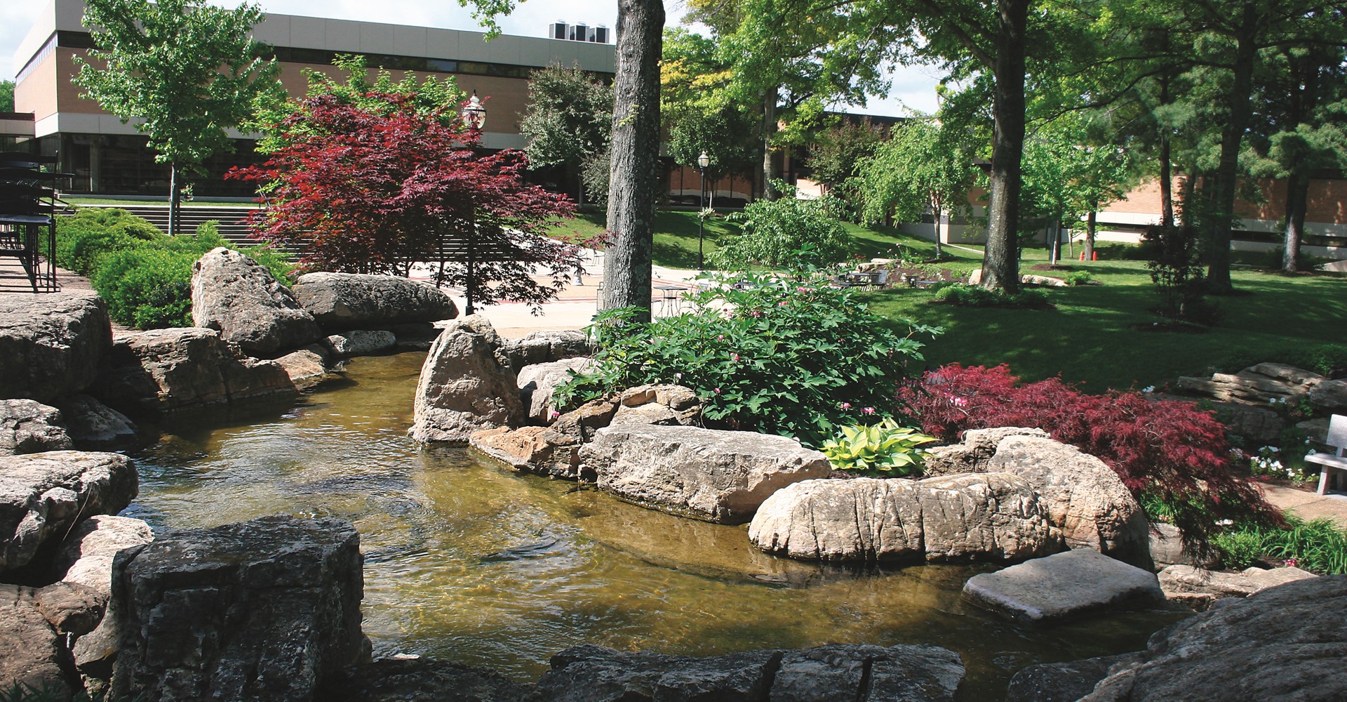 Image shows Mineral Area College's landscaping in the center of the main Park Hills campus, featuring a waterfall