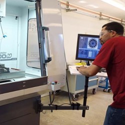Student working on a machine in a classroom.
