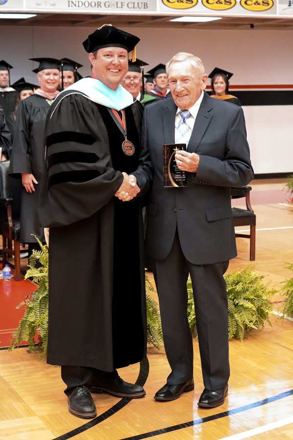 Dr. Gilgour presents Harvey Faircloth with the Simmons Distinguished Service Award at the 2023 Commencement Ceremony