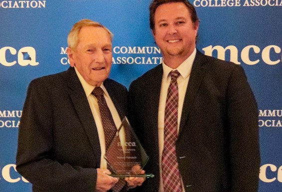 Photo of Harvey Faircloth and Dr. Joe Gilgour in front of MCCA backdrop